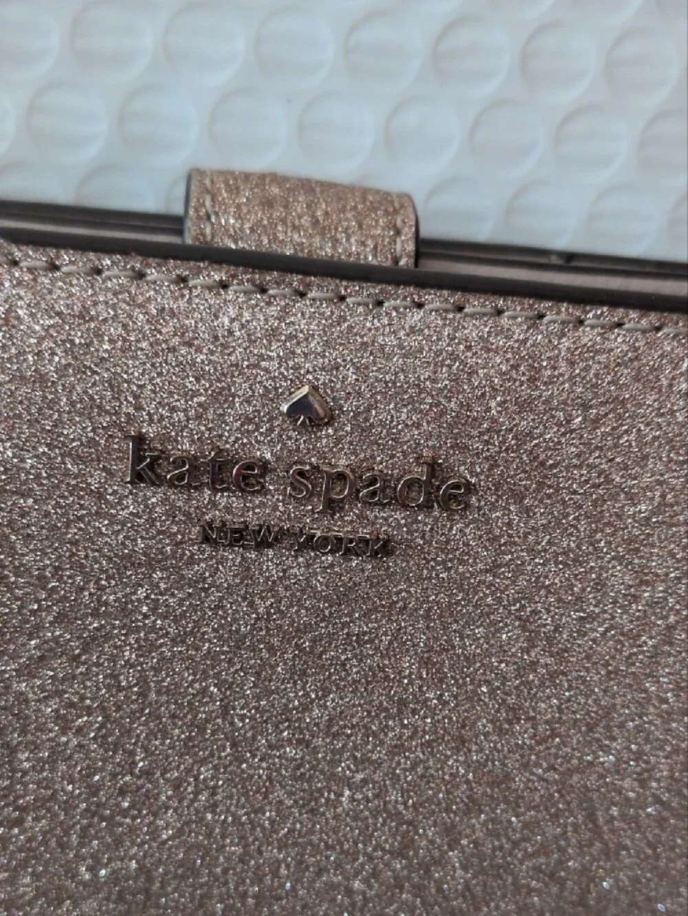 kate spade glitter wallet in rose gold shimmer